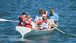 a group of people riding on the back of a boat in the water a group of people riding on the back of a boat in the water