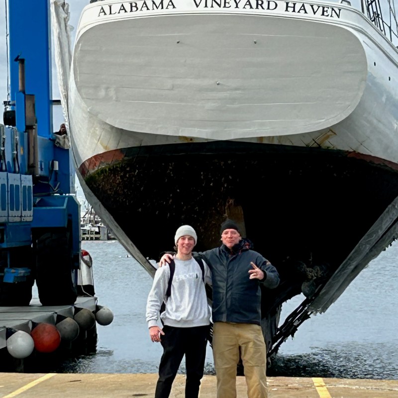 a man standing in front of a boat